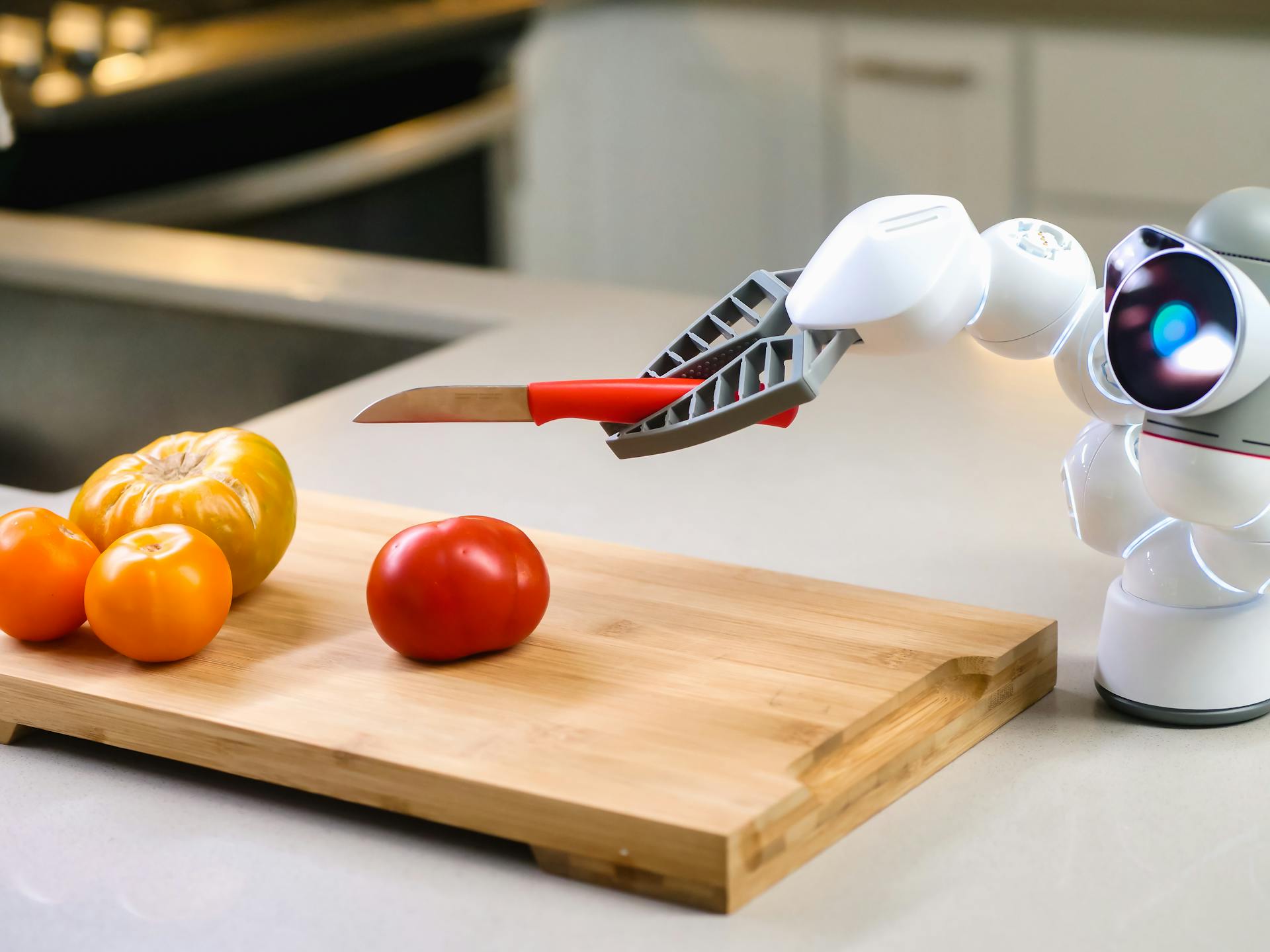 Robot arm holding a knife to cut tomatoes on a wooden board, symbolizing advanced automation and AI technology in everyday tasks.