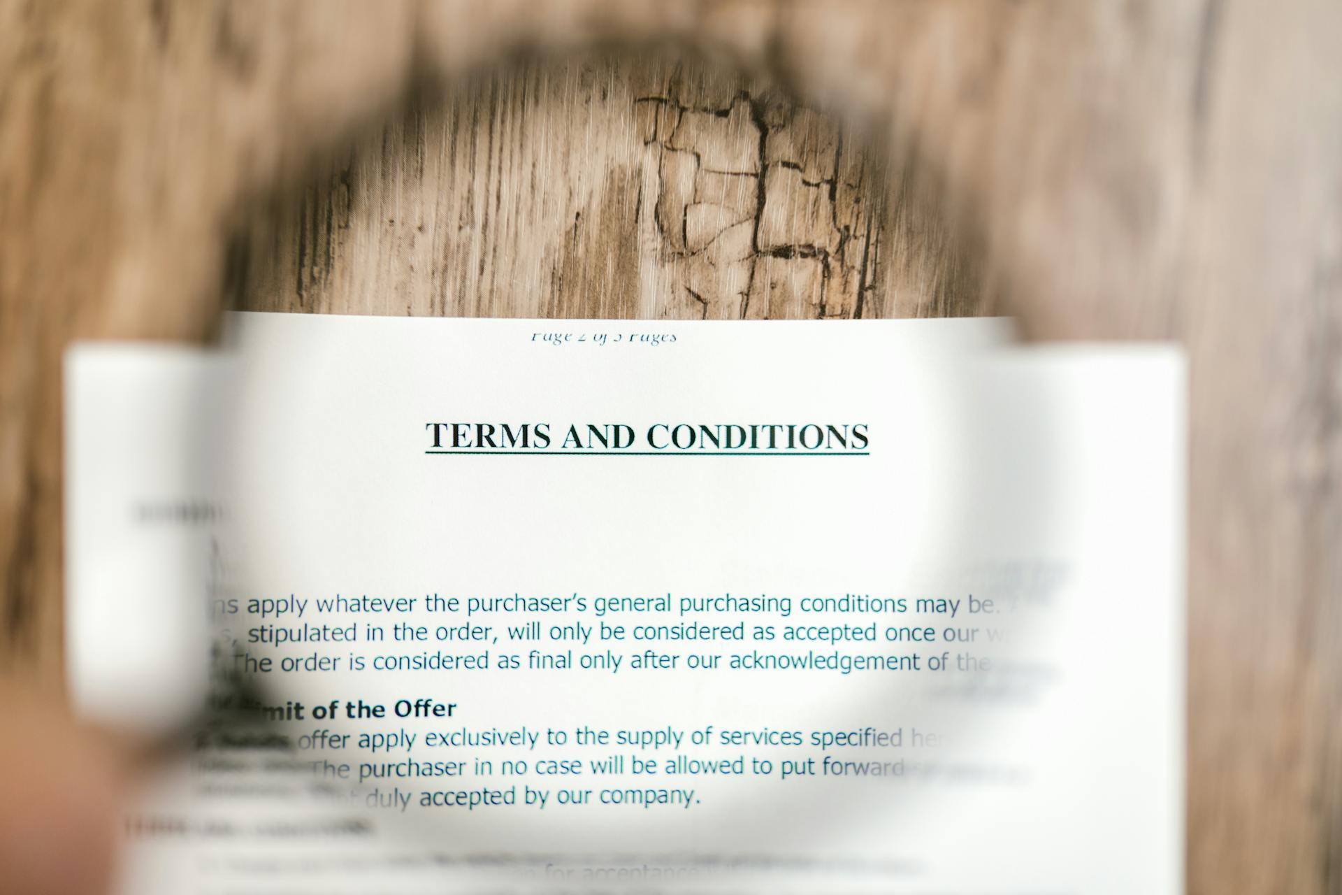 Close-up of a “Terms and Conditions” document viewed through a magnifying glass, symbolizing legal compliance, policy transparency, and regulatory considerations in global ecommerce and international SEO.