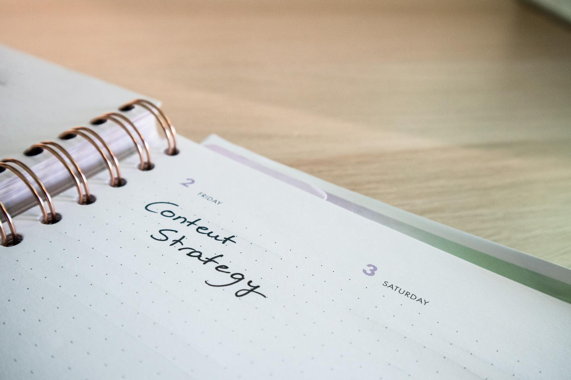 Close-up of a planner with “Content Strategy” written on a Friday date, symbolizing digital marketing planning, SEO content scheduling, and strategic execution for global online visibility.