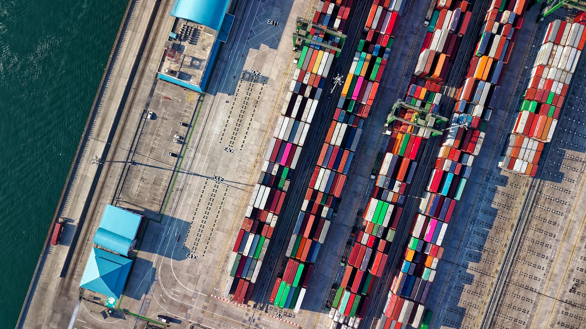 Aerial view of a busy international shipping port with rows of colorful cargo containers, highlighting global logistics, cross-border ecommerce, and supply chain infrastructure.