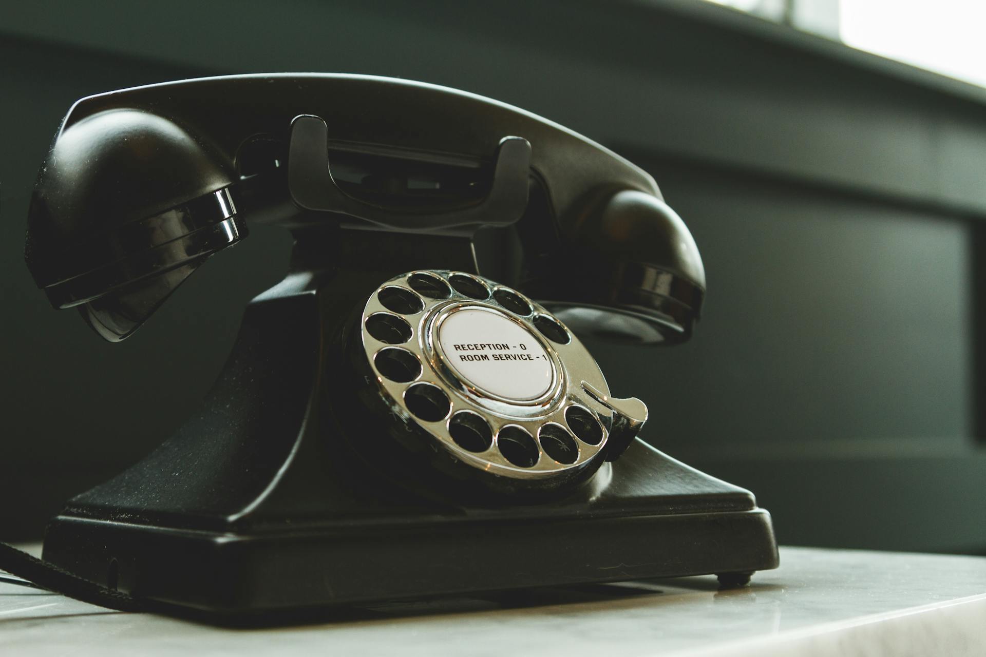 Retro rotary phone labeled “room service” — a charming reminder of how far customer service automation has come.